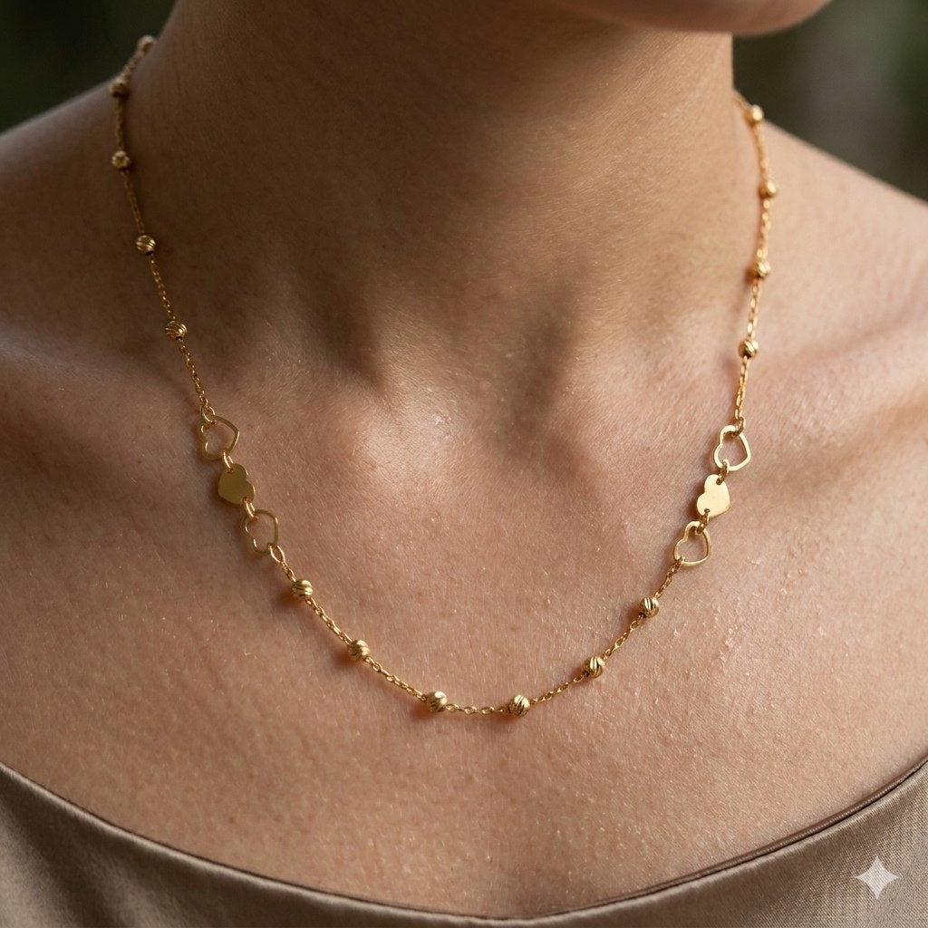 DIJE DE ORO 10K CON ESLABONES DE CORAZONES Y BALINES 22CM PESO: 2G